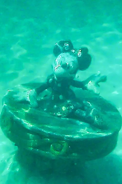 a Minnie Mouse statue in the ocean