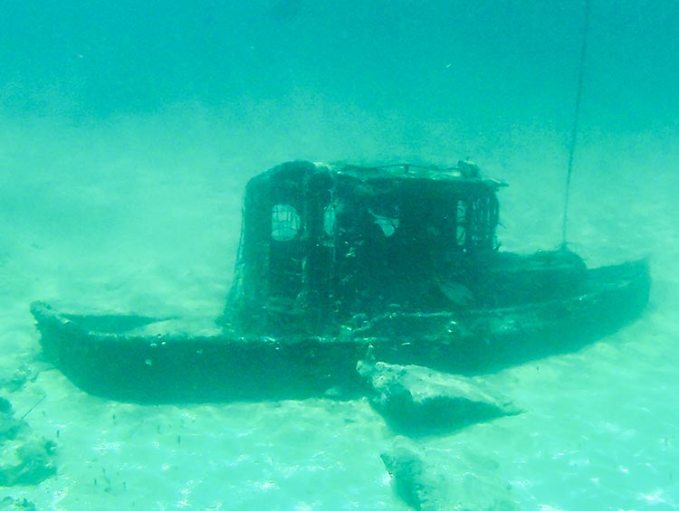 a sunken tugboat in the ocean