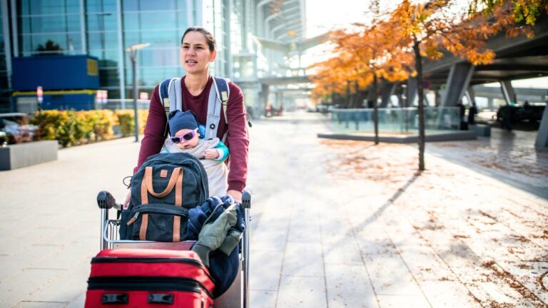 woman traveling with her baby and luggage
