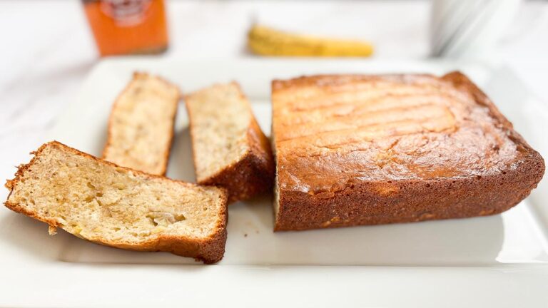 loaf of 3-ingredient banana bread with three slices on a white platter