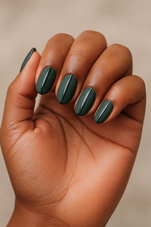 medium almond Christmas nails with dark green polish