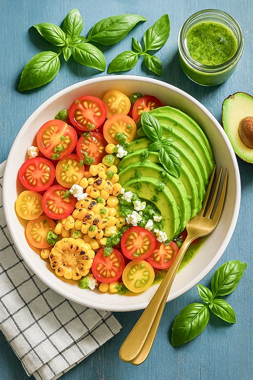 bowl of grilled corn tomato avocado salad