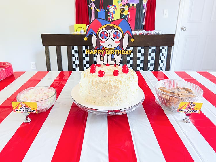 kitchen table decorated for Amazing Digital Circus birthday party including cake