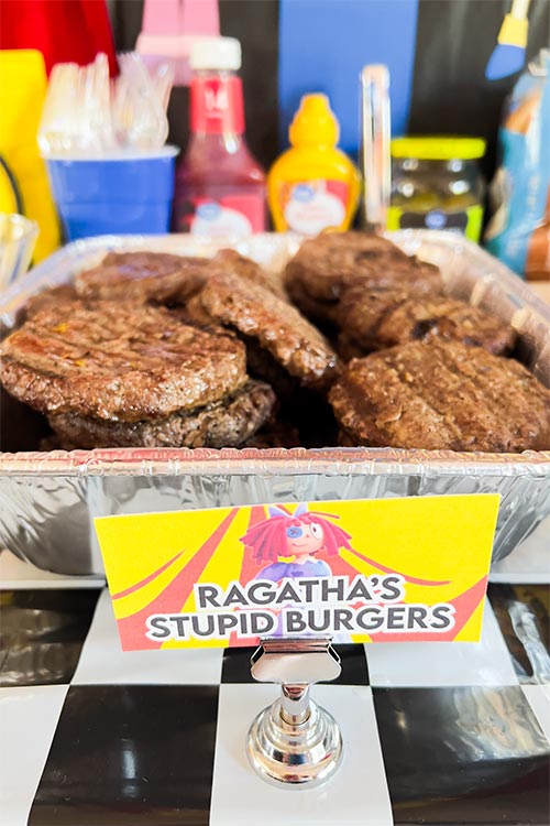 tray of burgers labeled Ragatha's Stupid Burgers