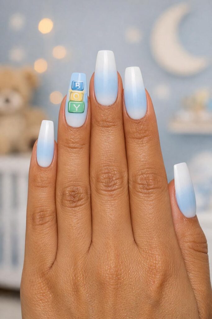 Blue ombre nails with baby block accent spelling boy