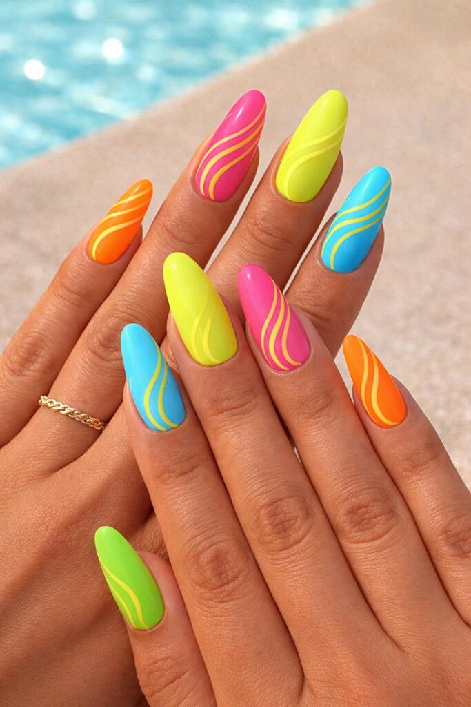 Neon summer nails in pink, orange, yellow, and blue with wavy lines