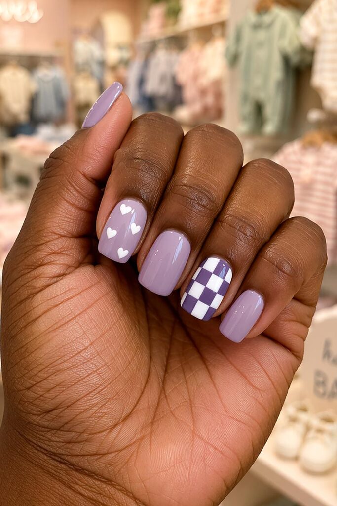 Dusty purple nails with heart accents and checkerboard design
