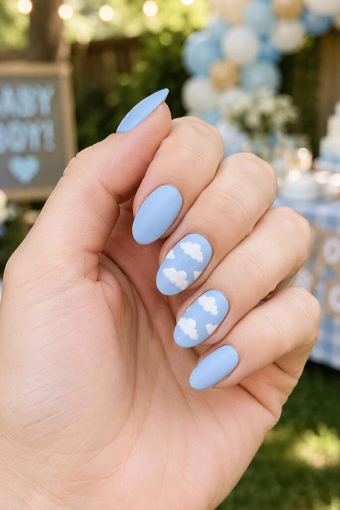 Matte baby blue nails with white cloud designs