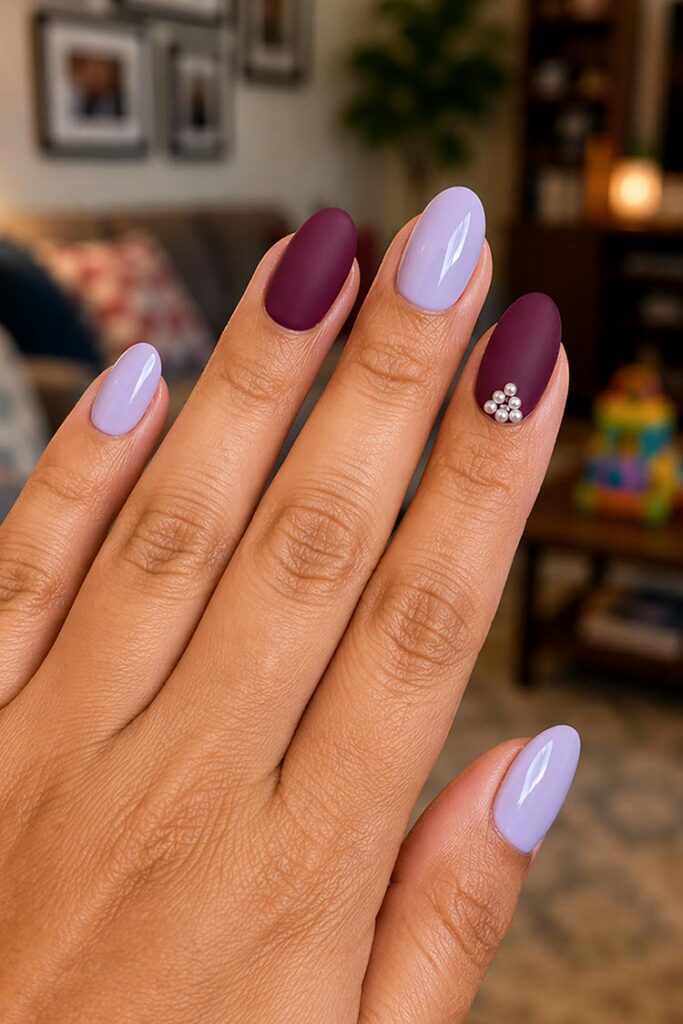 Matte plum and glossy lilac nails with pearl accent