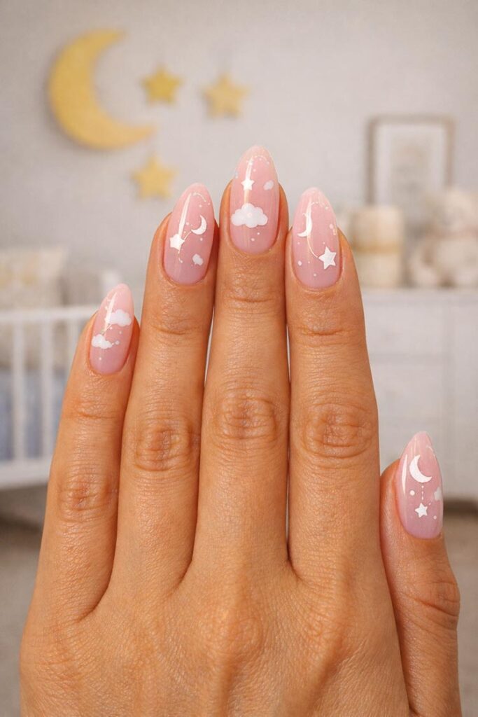 Soft pink nails with clouds, stars, and moon nail art
