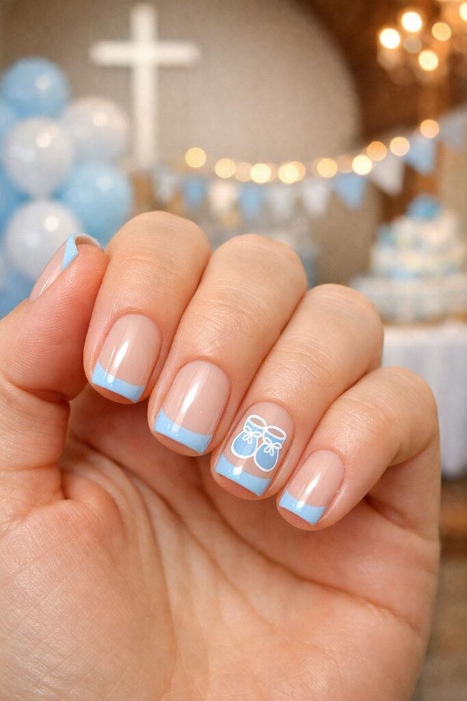 Short nails with blue French tips and baby booties design