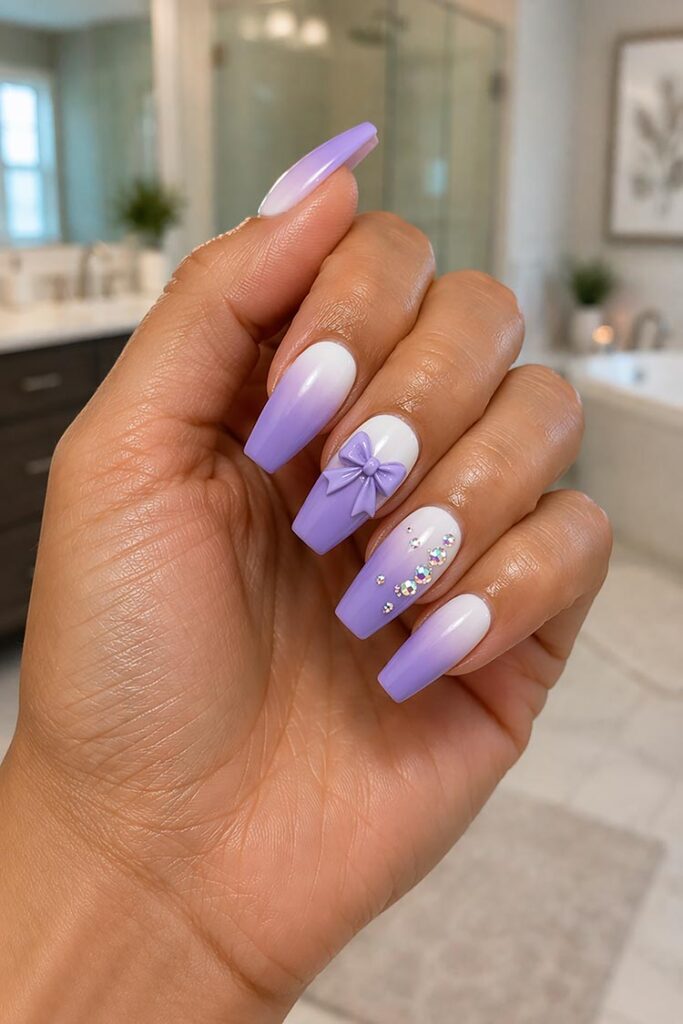 Purple ombre nails with 3D bow and rhinestone accents
