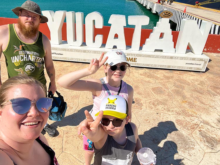 Family taking selfie at Yucatan sign in Progreso port