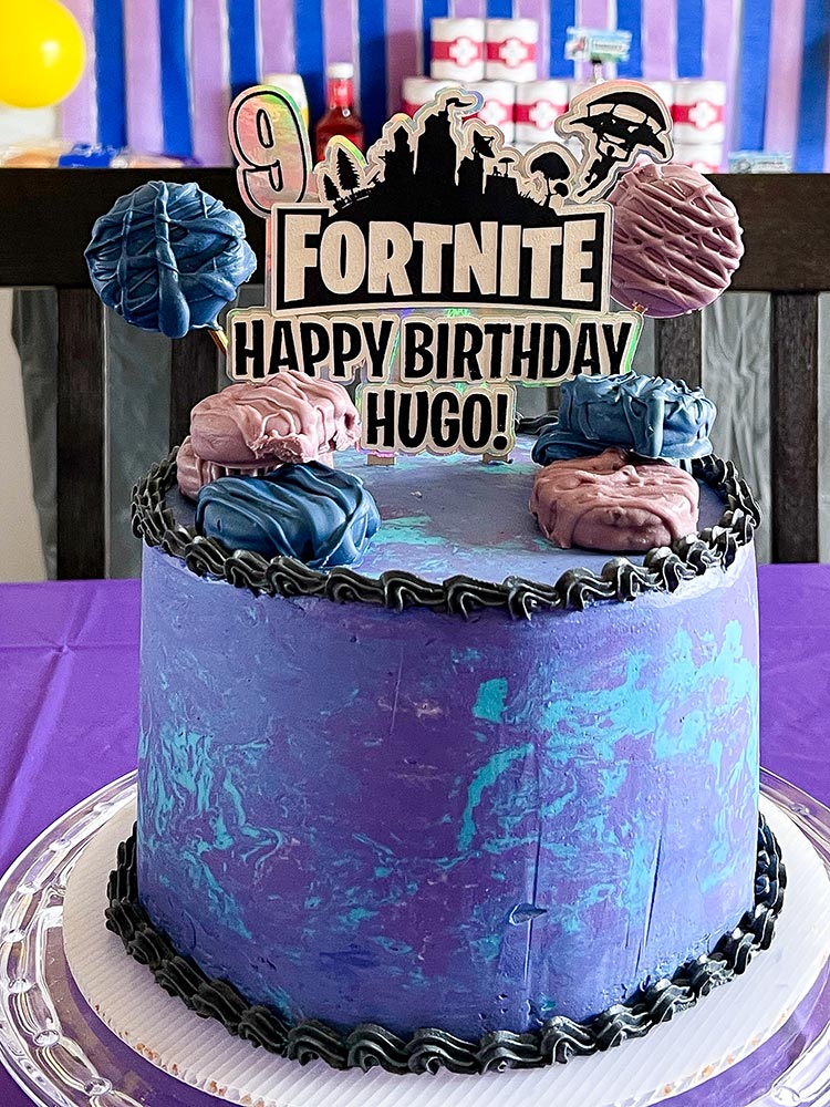 Fortnite themed marbled birthday cake with custom cake topper