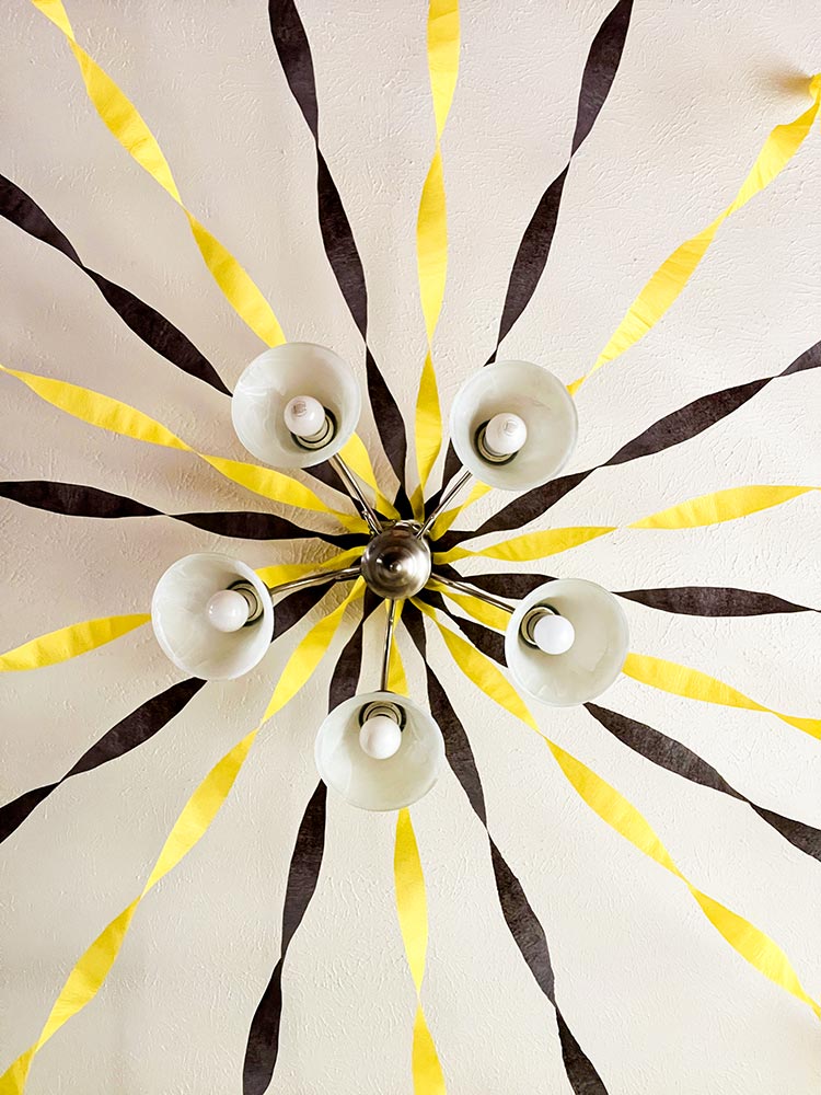 Fortnite party ceiling decorated with yellow and black streamers