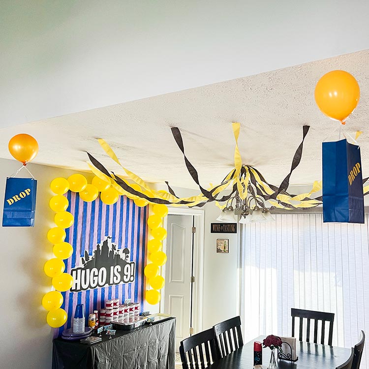 Fortnite birthday party room with decorations, balloons, and drop boxes