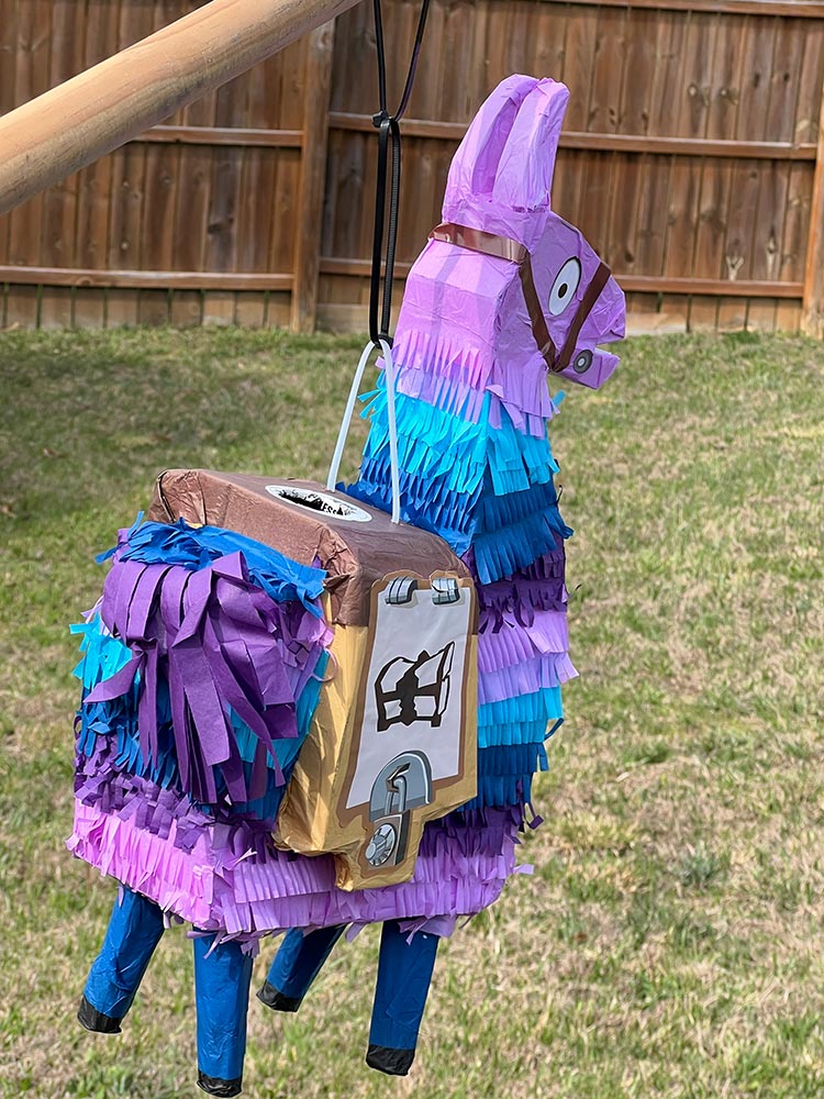 Colorful Fortnite Loot Llama pi&ntilde;ata hanging outdoors