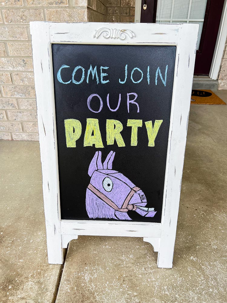 Chalkboard sign saying come join our party with Loot Llama drawing
