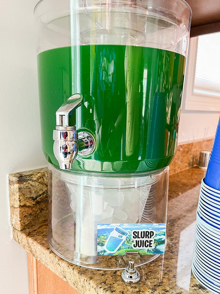 Green Fortnite Slurp Juice drink in dispenser with party label