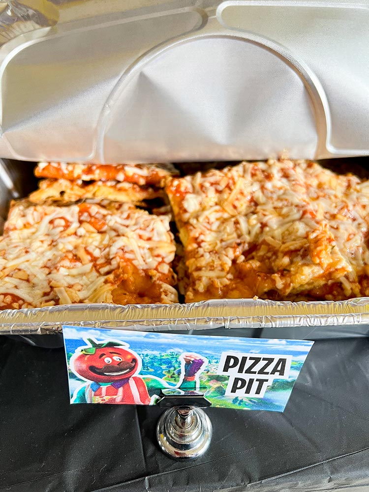 Fortnite Pizza Pit labeled tray of cheesy pizza slices