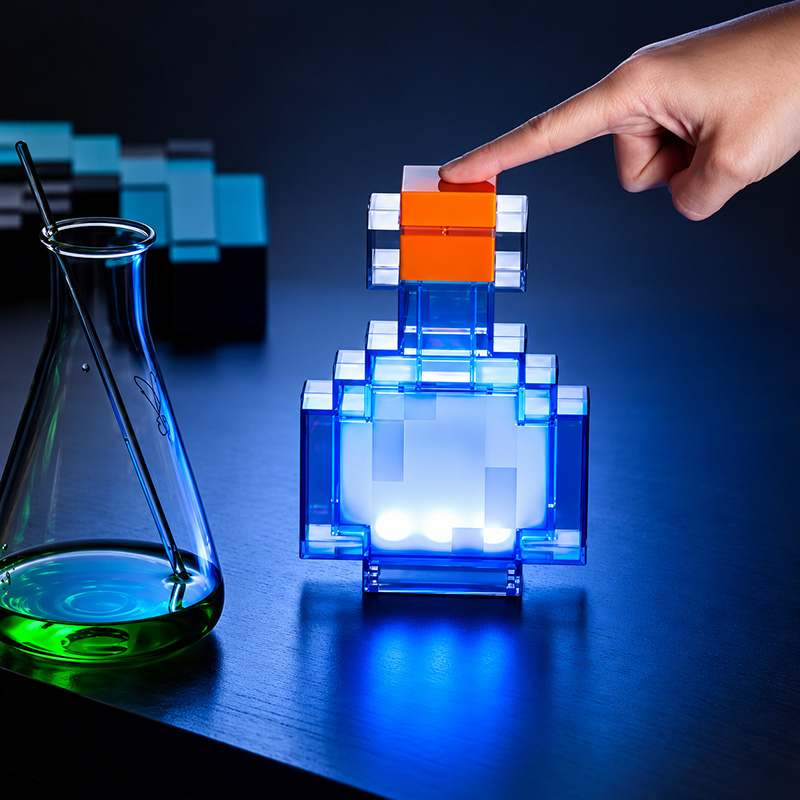 Glowing blue Minecraft potion bottle night-light beside a glass flask filled with green liquid.