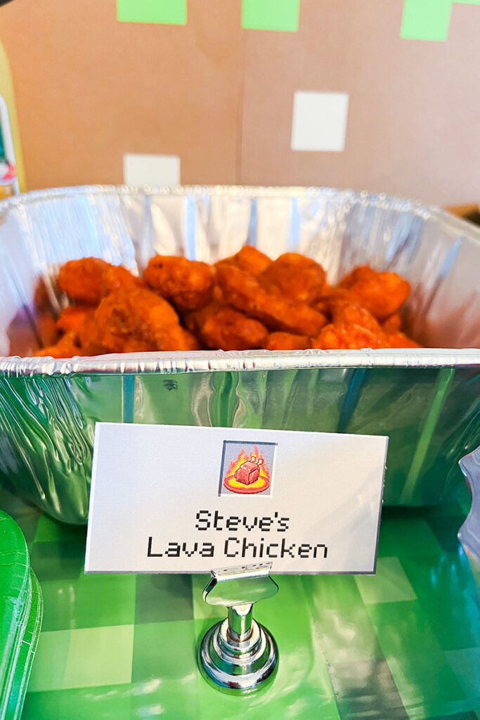 Tray of saucy chicken wings labeled “Steve’s Lava Chicken” with a Minecraft-style party food sign.