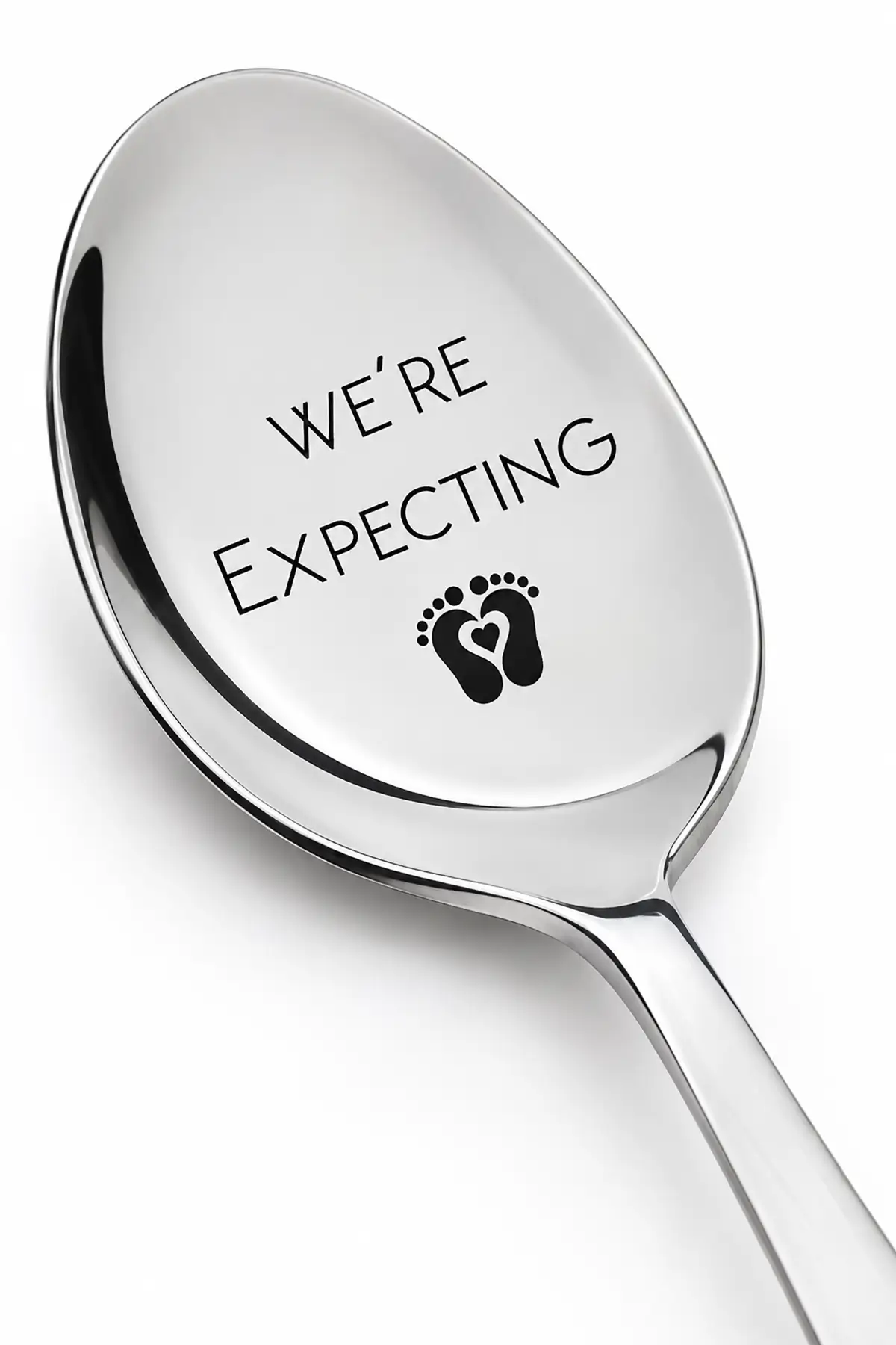 Silver spoon engraved with "We're Expecting" and tiny baby footprints, designed as a surprise pregnancy announcement gift for a husband.